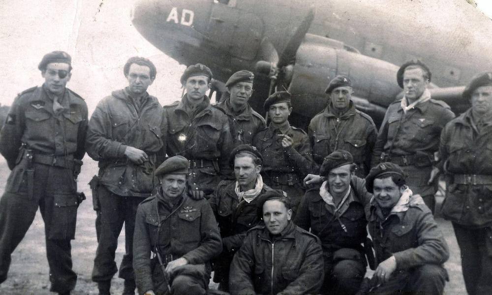 Photo d'archive en noir et blanc : groupe de parachutistes SAS devant un avion